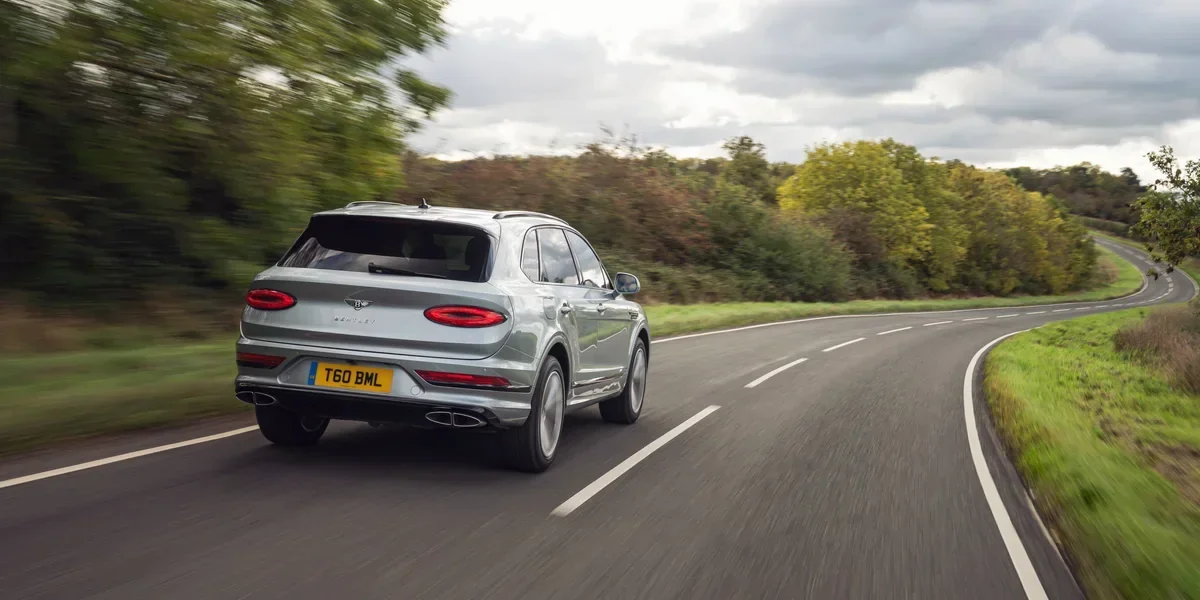 Bentley Bentayga rear three-quarter view on a country road